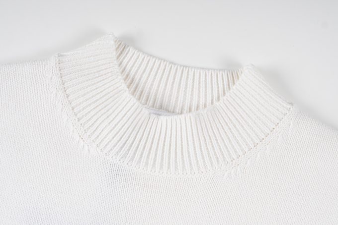 Prada's exclusive triangular logo design for a wool sweater