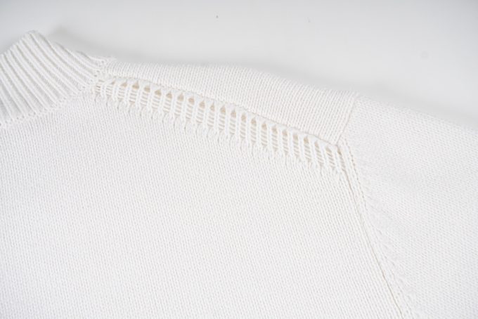 Prada's exclusive triangular logo design for a wool sweater