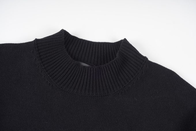 Prada's exclusive triangular logo design for a wool sweater