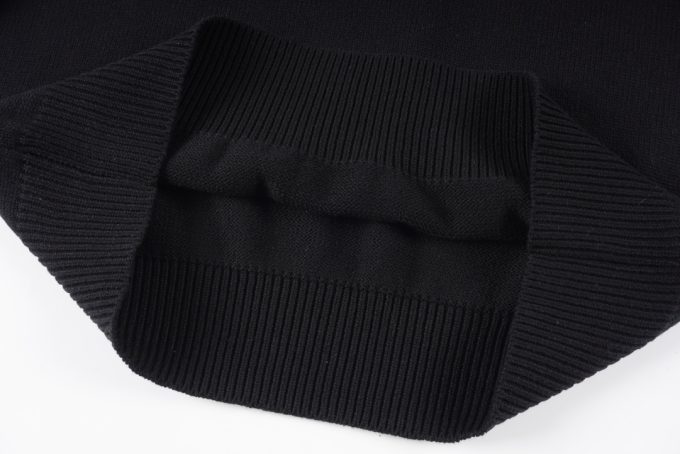 Prada's exclusive triangular logo design for a wool sweater