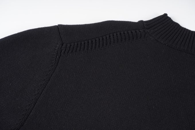 Prada's exclusive triangular logo design for a wool sweater